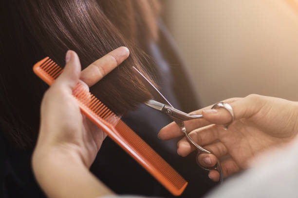 Cropped shot of a female client receiving a haircut at the local beauty salon. Healthy hair tips concept